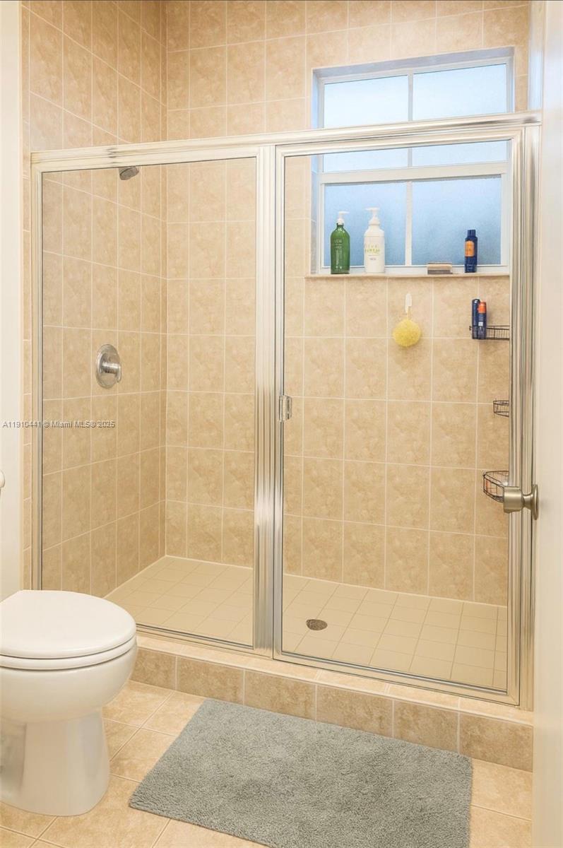 1002 Southwest 144th Avenue, Unit 605 Pembroke Pines, FL 33027 - Photo 14 of 18 a bathroom with a shower and a toilet