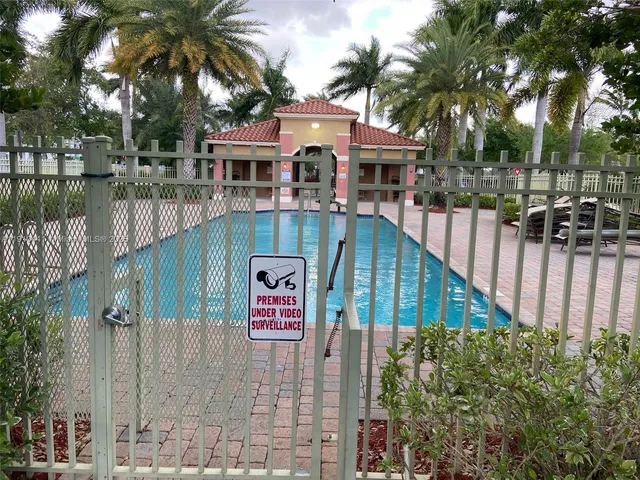 a front view of house with yard and sign board