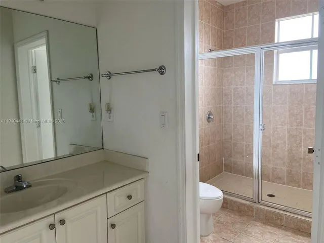 a bathroom with a shower toilet and sink