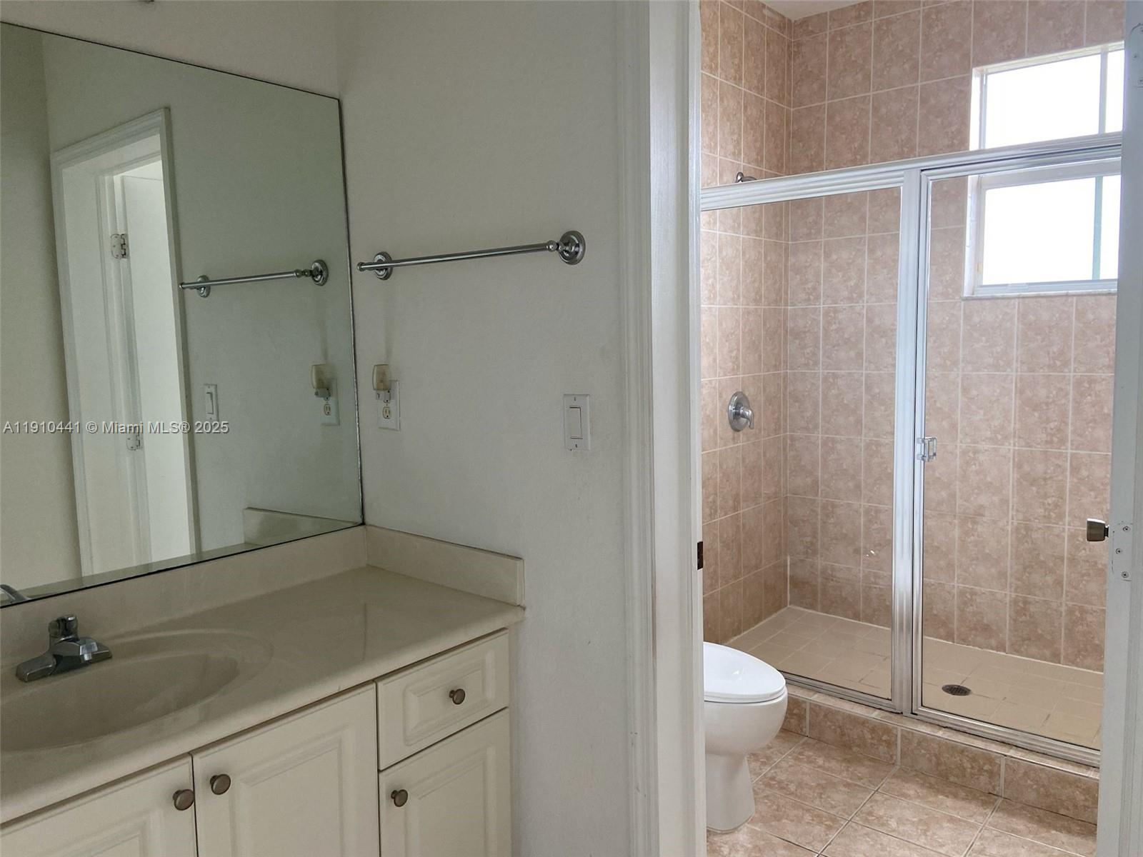 1002 Southwest 144th Avenue, Unit 605 Pembroke Pines, FL 33027 - Photo 18 of 18 a bathroom with a shower toilet and sink