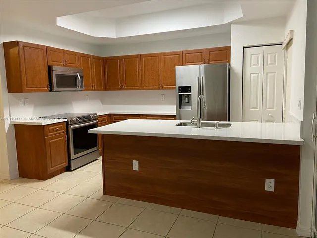 a kitchen with a sink and a refrigerator