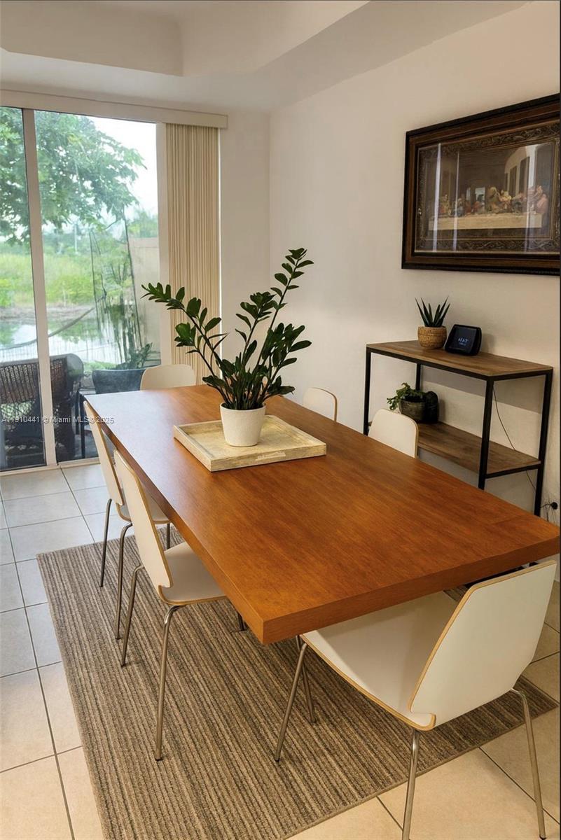 1002 Southwest 144th Avenue, Unit 605 Pembroke Pines, FL 33027 - Photo 4 of 18 a dining room with furniture