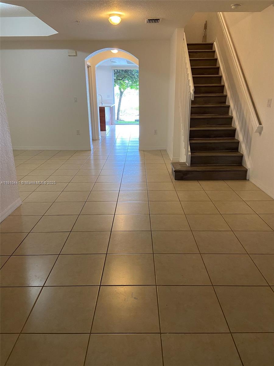 1002 Southwest 144th Avenue, Unit 605 Pembroke Pines, FL 33027 - Photo 6 of 18 a view of a livingroom with wooden floor and entertaining space