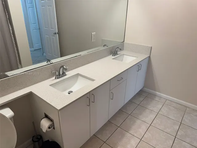 a bathroom with a sink vanity and mirror