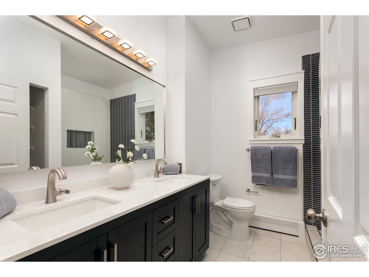 751 Grant Place Boulder, CO 80302 - Photo 24 of 38 Freshly updated, windowed en suite bathroom with new double vanity, large rain shower, stylish tilework, and contemporary fixtures (2026).