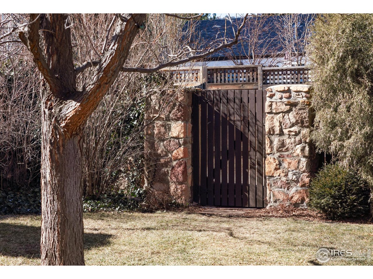 751 Grant Place Boulder, CO 80302 - Photo 35 of 38 Wooden gate on the north side of the home and charming, fully fenced outdoor spaces designed for dining, lounging, and entertaining.