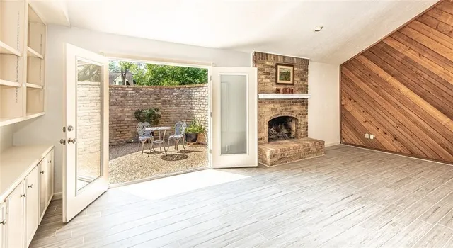 a view of a living room with furniture wooden floor and a window