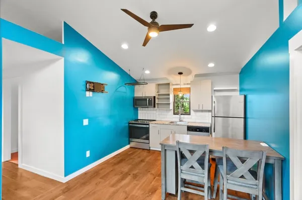 a kitchen with a table and chairs in it