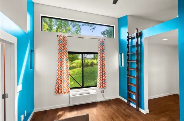 a view of an entryway with wooden floor and door