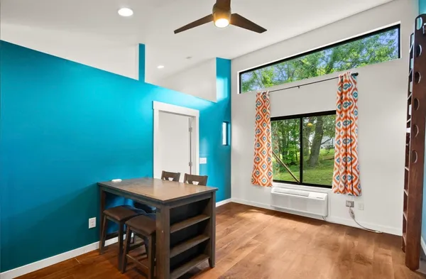 a room with pool table and windows