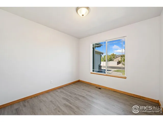 a view of room with wooden floor and window