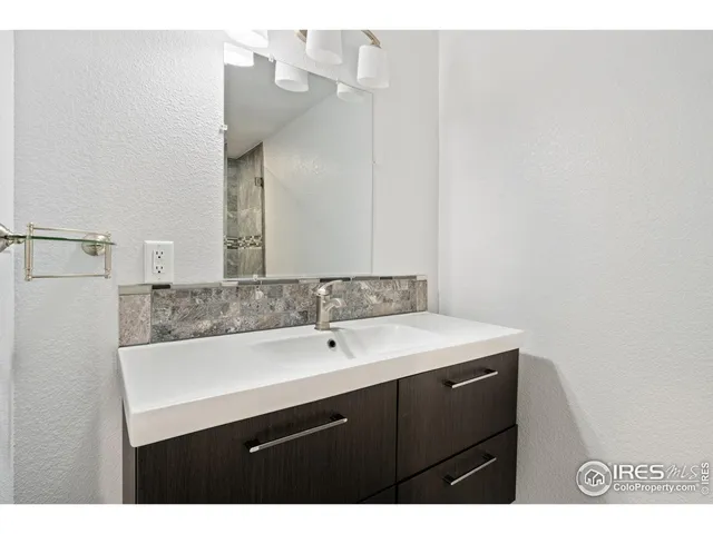 a bathroom with a sink vanity and a mirror