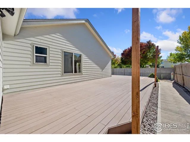 a view of a balcony with wooden floor and fence