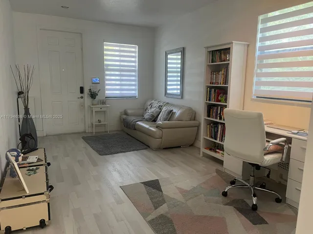a livingroom with workspace and a window