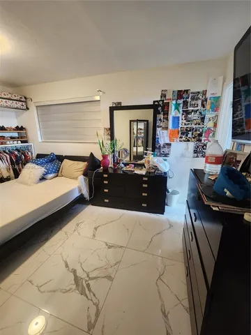 a bedroom with furniture and a flat screen tv