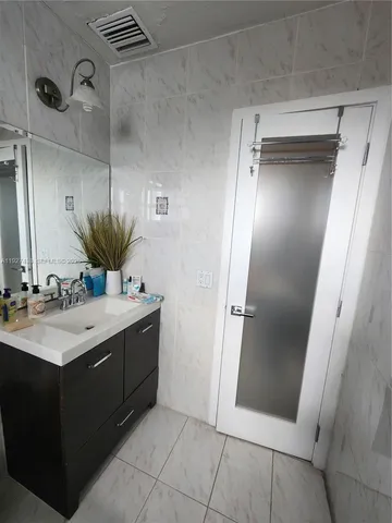 a bathroom with a double vanity sink and mirror