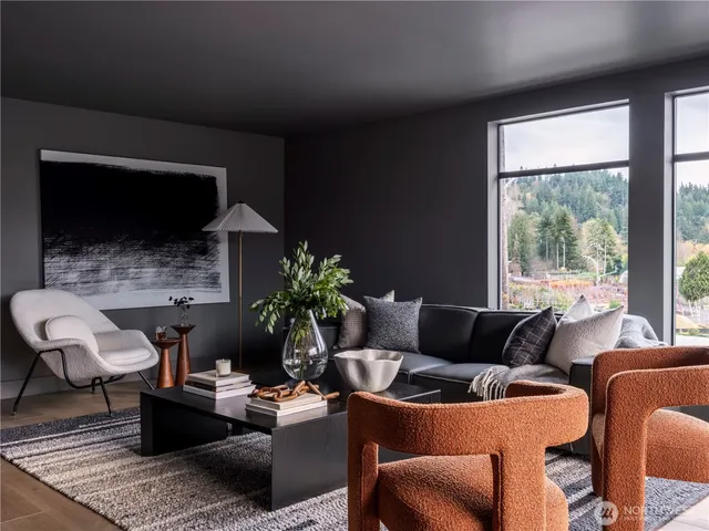 a living room with furniture a flat screen tv and a large window