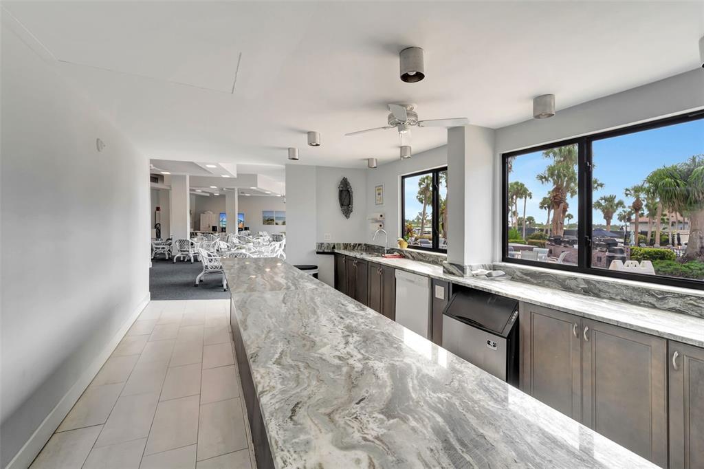 5855 Midnight Pass Road, Unit 314 Sarasota, FL 34242 - Photo 13 of 58 a large white kitchen with a large window