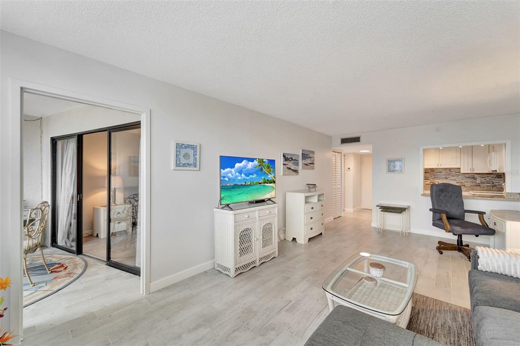 5855 Midnight Pass Road, Unit 314 Sarasota, FL 34242 - Photo 15 of 58 a view of a livingroom with furniture and a flat screen tv