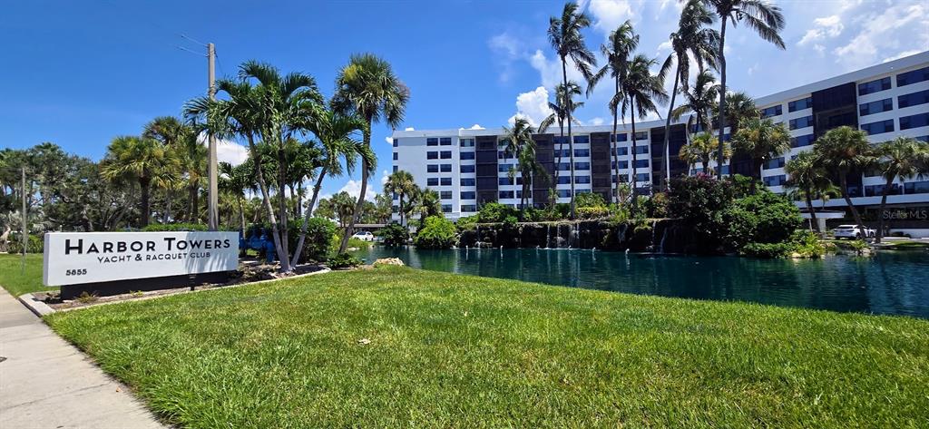 5855 Midnight Pass Road, Unit 314 Sarasota, FL 34242 - Photo 2 of 58 a view of swimming pool outdoor seating and lake