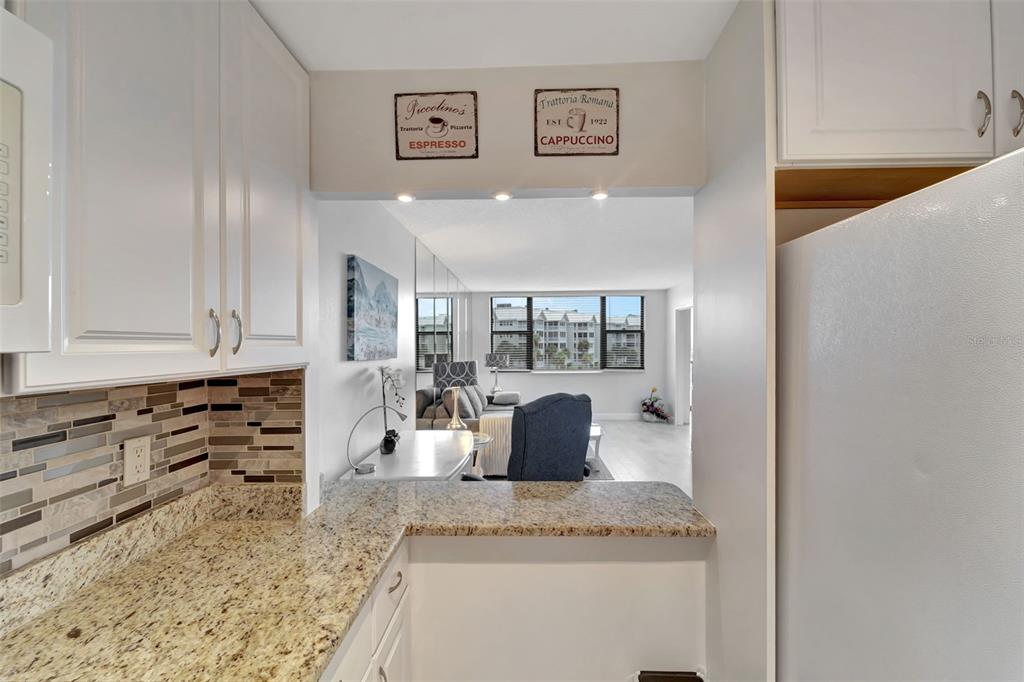 5855 Midnight Pass Road, Unit 314 Sarasota, FL 34242 - Photo 22 of 58 a kitchen with granite countertop a sink and cabinets