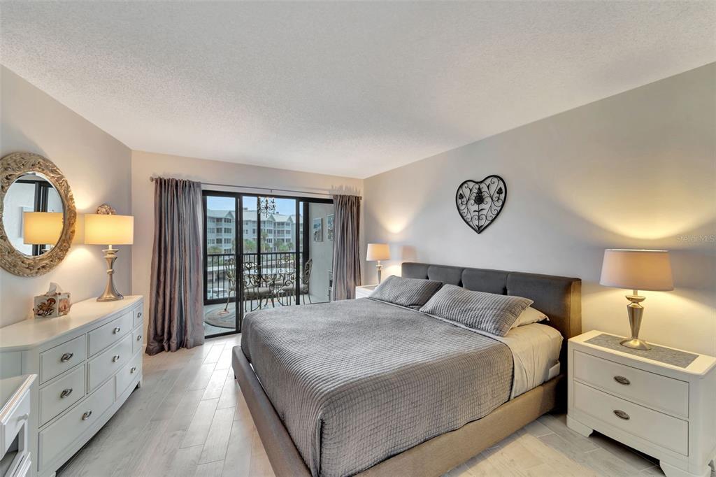 5855 Midnight Pass Road, Unit 314 Sarasota, FL 34242 - Photo 23 of 58 a bedroom with a bed and a dresser