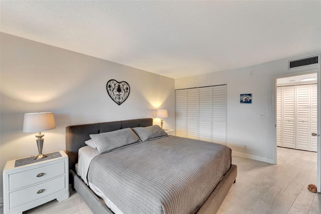 5855 Midnight Pass Road, Unit 314 Sarasota, FL 34242 - Photo 24 of 58 a bedroom with a bed and a lamp