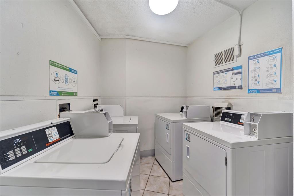 5855 Midnight Pass Road, Unit 314 Sarasota, FL 34242 - Photo 31 of 58 a utility room with dryer and washer
