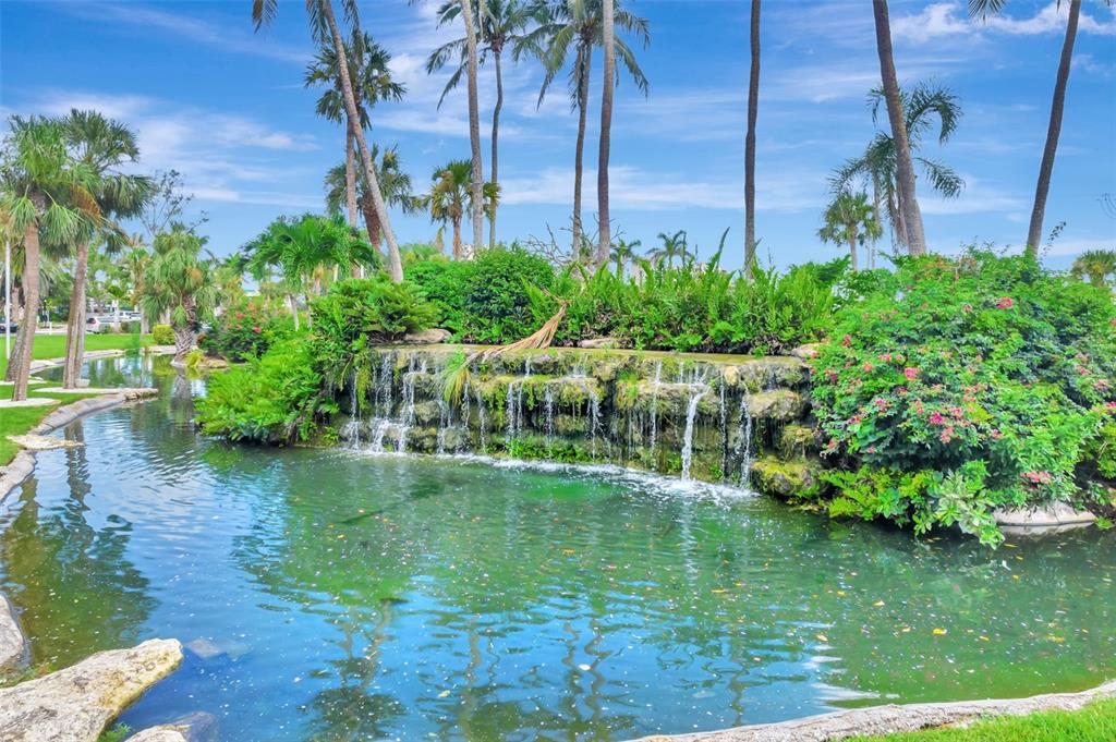 5855 Midnight Pass Road, Unit 314 Sarasota, FL 34242 - Photo 46 of 58 a view of a garden with a lake