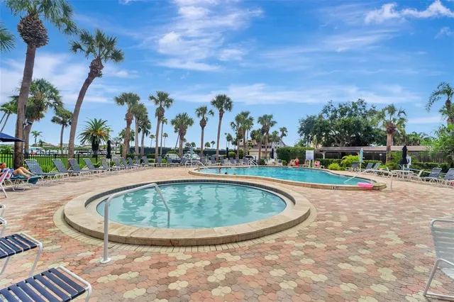 a view of swimming pool with outdoor seating and plants