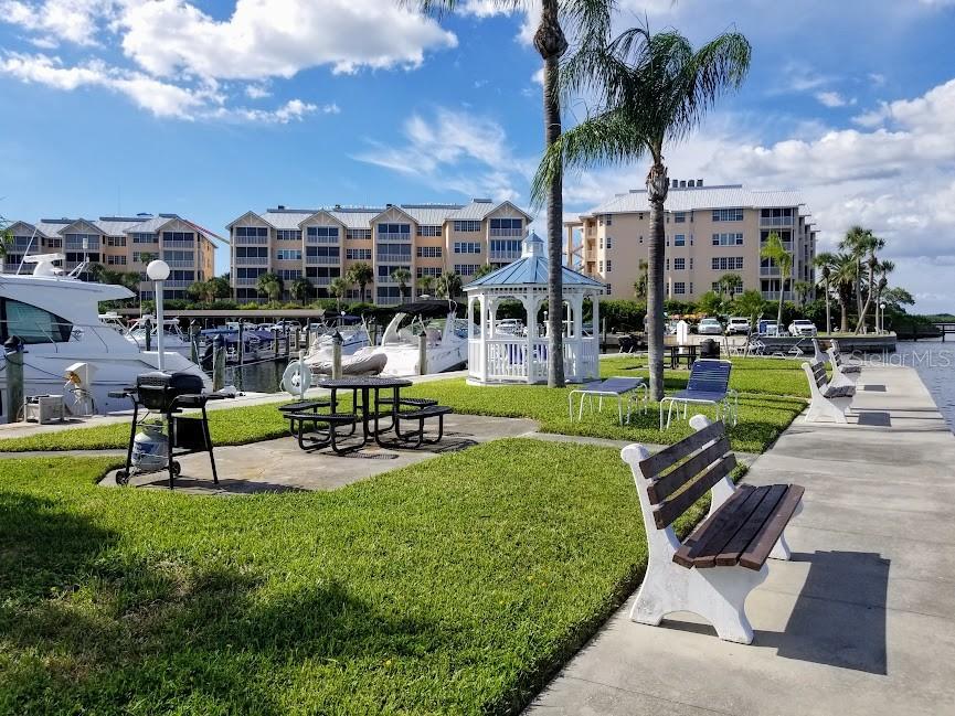 5855 Midnight Pass Road, Unit 314 Sarasota, FL 34242 - Photo 56 of 58 a view of a swimming pool and lounge chairs