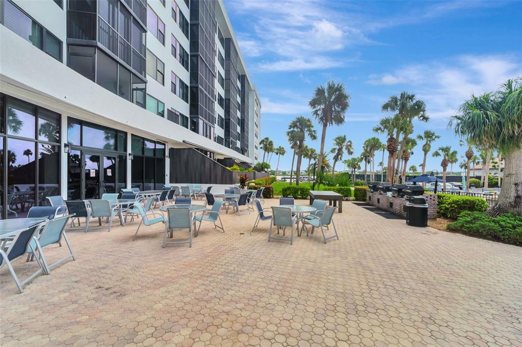 5855 Midnight Pass Road, Unit 314 Sarasota, FL 34242 - Photo 10 of 58 a view of a building with sitting area and garden