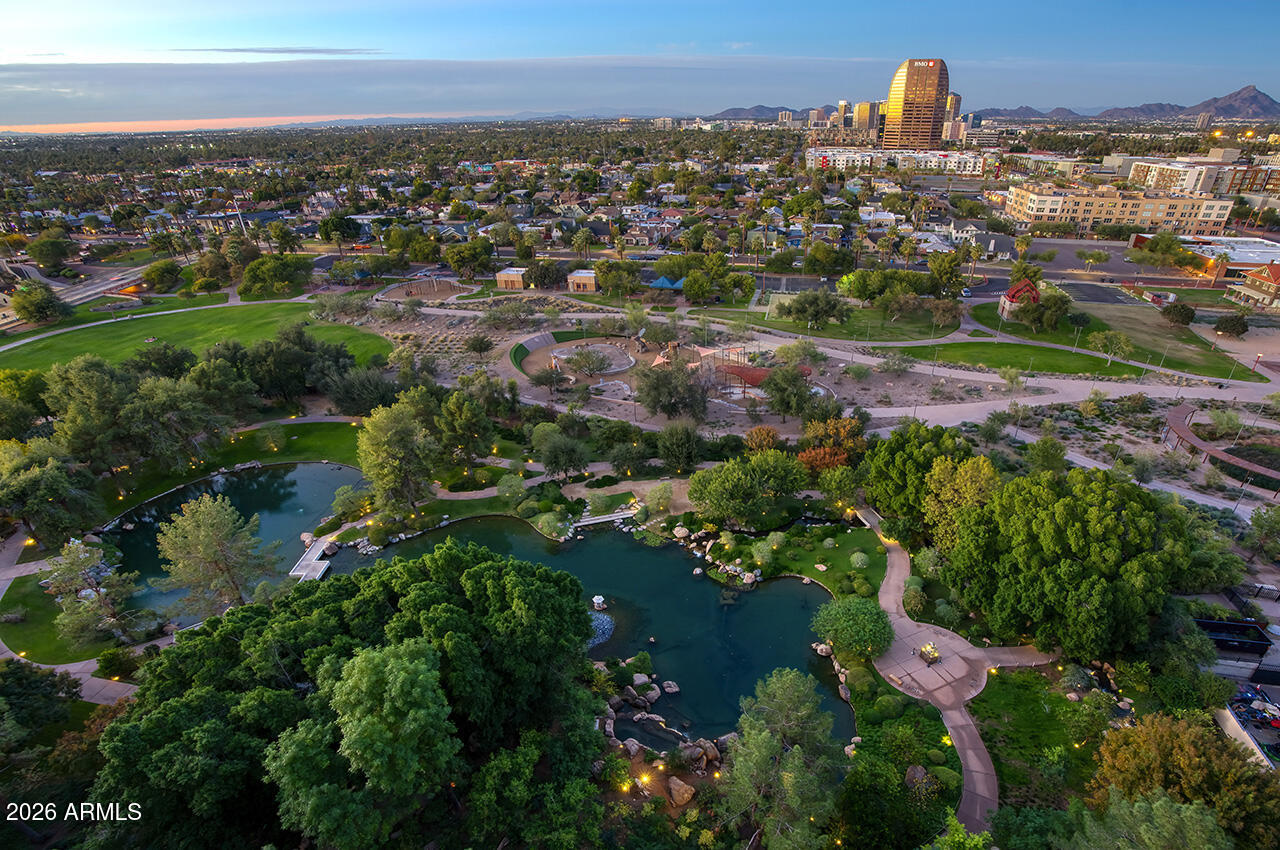 an aerial view of residential houses with outdoor space and trees