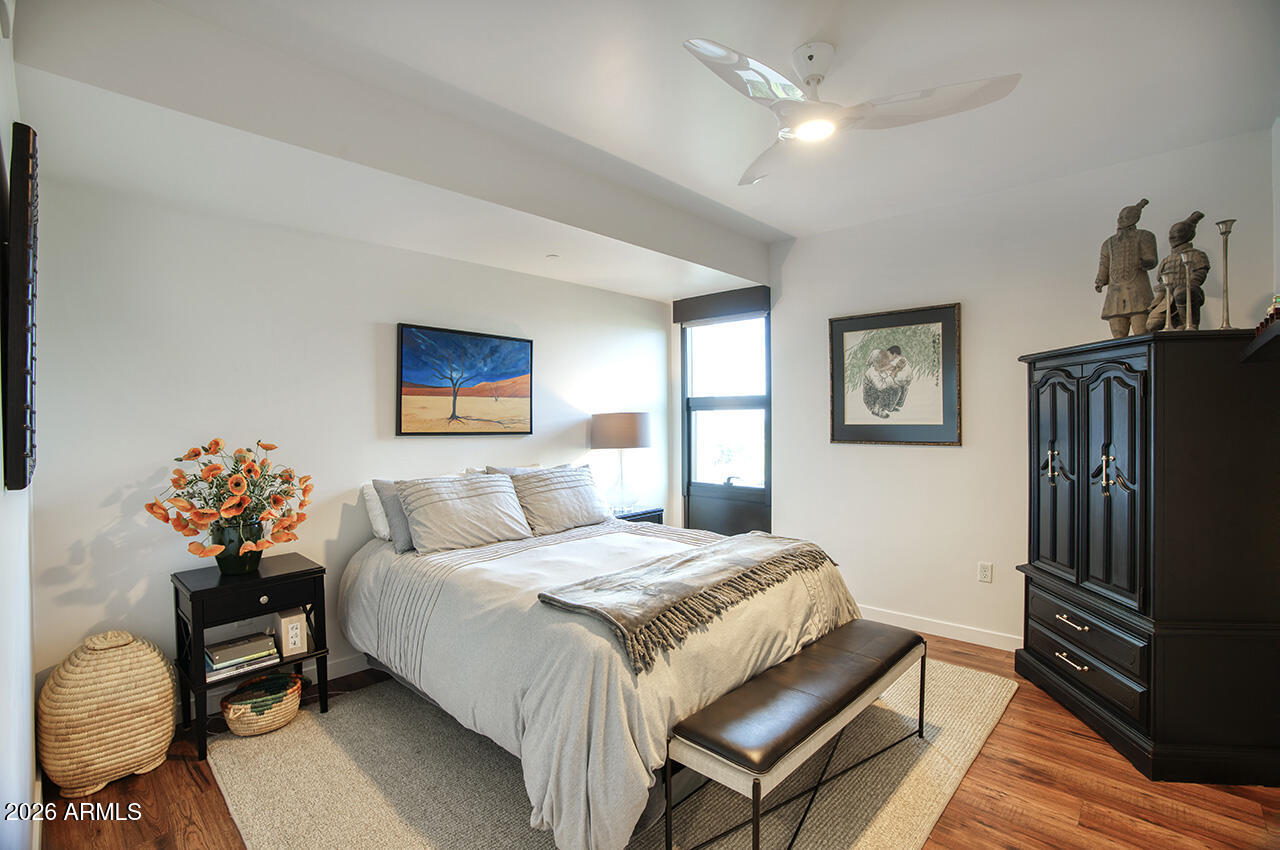 200 West Portland Street, Unit 822 Phoenix, AZ 85003 - Photo 22 of 61 a bedroom with a bed and a chandelier