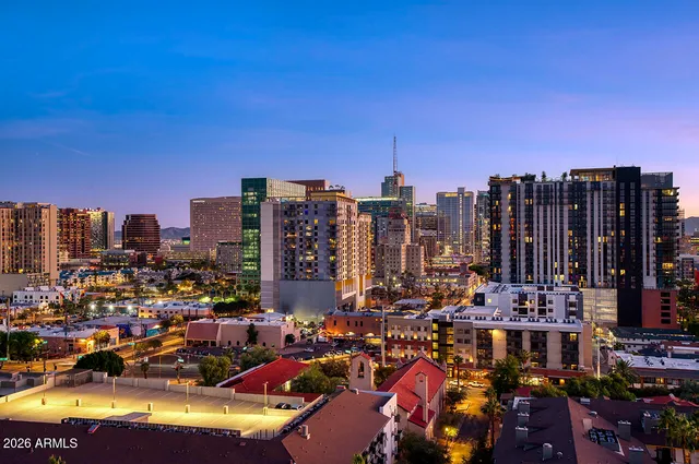 a view of a patio with table and chairs under an umbrella next to a yard
