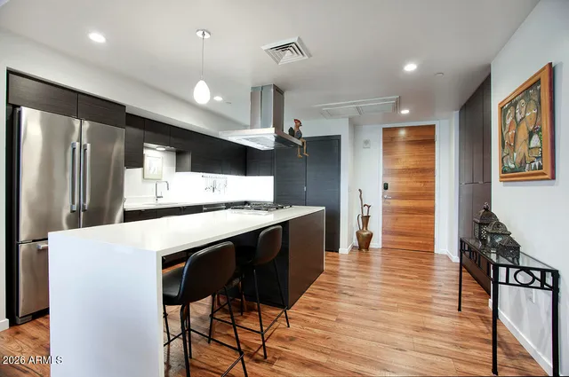 a kitchen with stainless steel appliances granite countertop a stove and cabinets