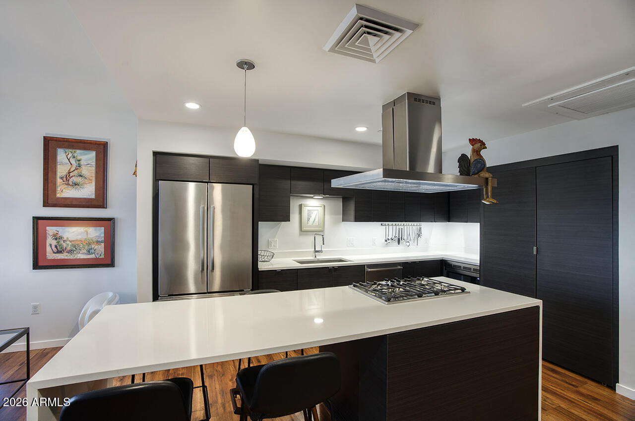 200 West Portland Street, Unit 822 Phoenix, AZ 85003 - Photo 7 of 61 a kitchen with stainless steel appliances a stove refrigerator and cabinets