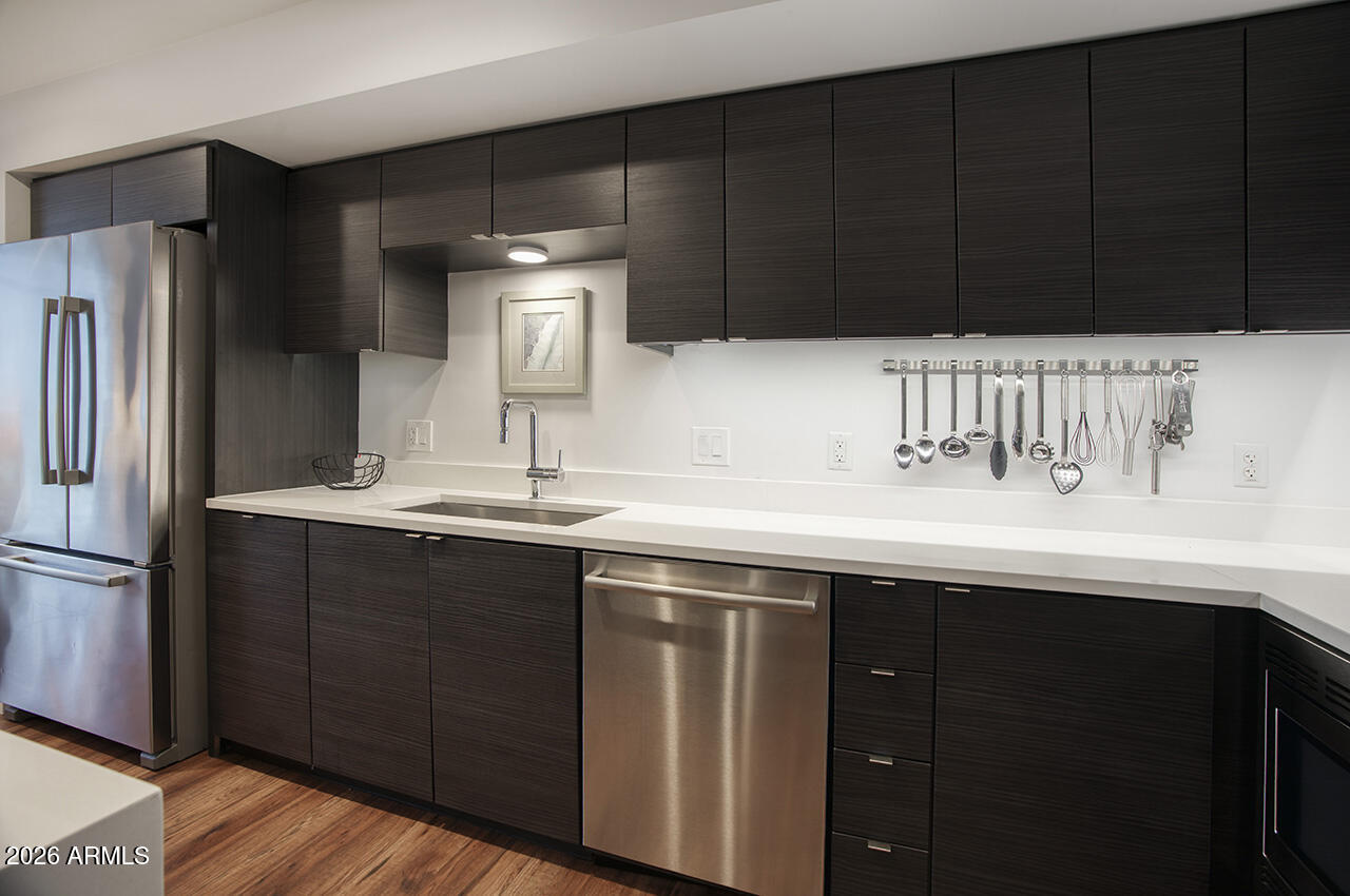200 West Portland Street, Unit 822 Phoenix, AZ 85003 - Photo 8 of 61 a sink with cabinets and stainless steel appliances