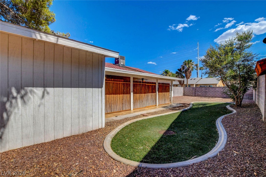 4367 South Mojave Road Las Vegas, NV 89121 - Photo 51 of 53 A private yard with vibrant green grass and decorative rock landscaping awaits outdoor enjoyment.