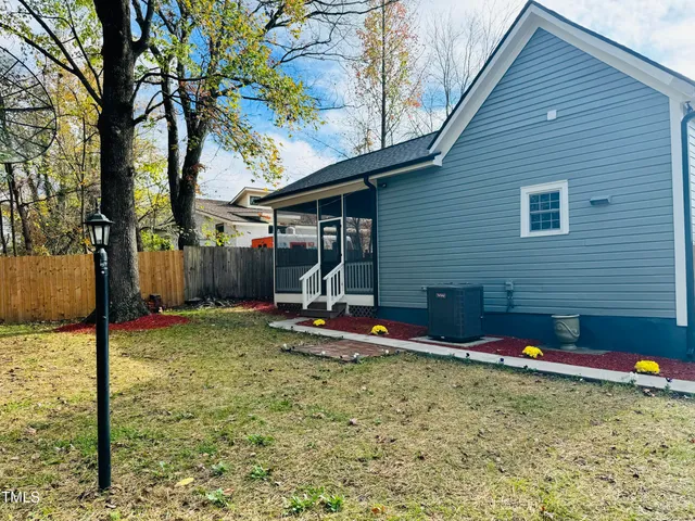 a view of a backyard with a tree
