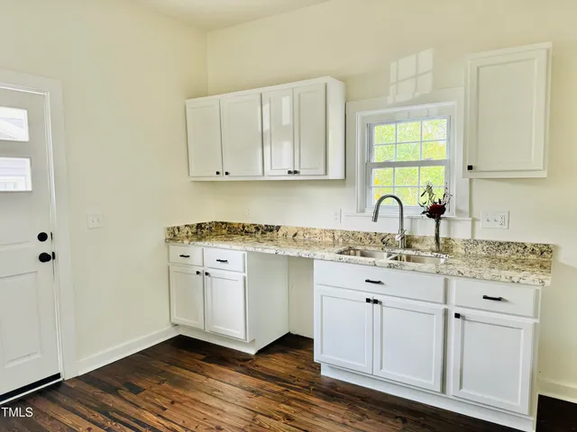 a view of a hardwood floor and a floor to ceiling window
