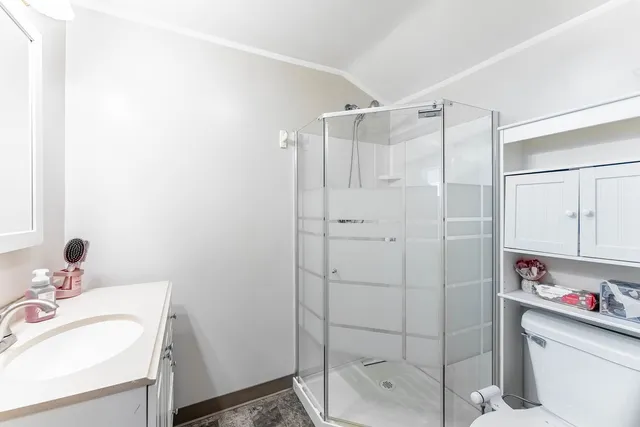 a spacious bedroom with a bed and a chandelier