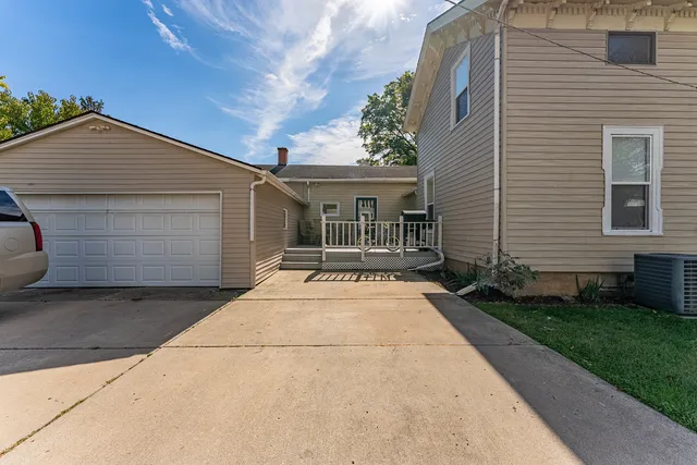 a backyard of a house with a table and chairs
