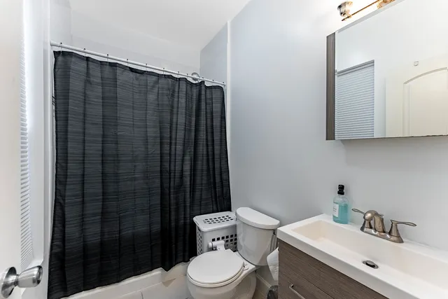 a bathroom with a shower toilet and sink