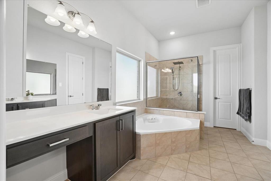 2721 Rotherham Street Prosper, TX 75078 - Photo 14 of 37 a spacious bathroom with a bathtub shower sink and mirror