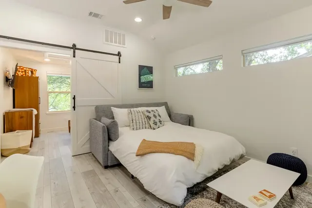 a bedroom with a bed and window