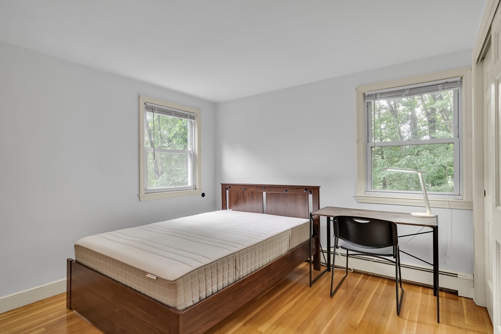 32 Dewey Road Lexington, MA 02420 - Photo 20 of 32 a bedroom with a bed a table and a window