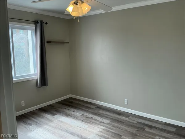 a kitchen with a sink and a stove with wooden floor