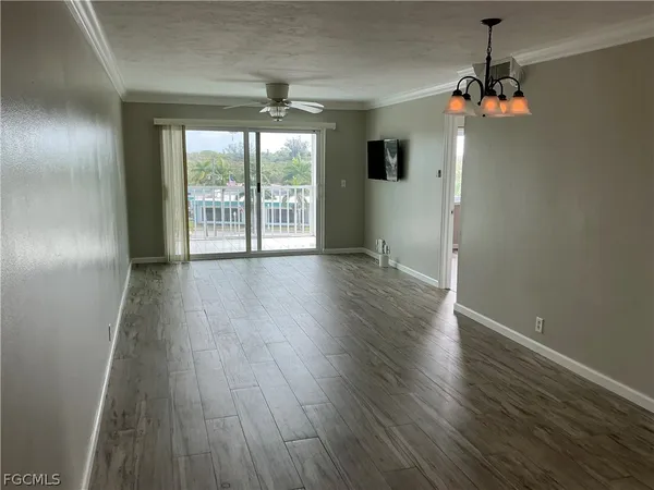 a kitchen with kitchen island granite countertop a sink cabinets and window