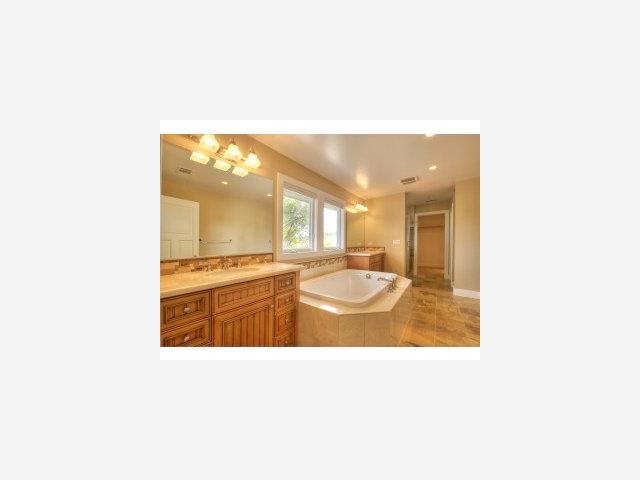 a bathroom with a sink a mirror and a bath tub
